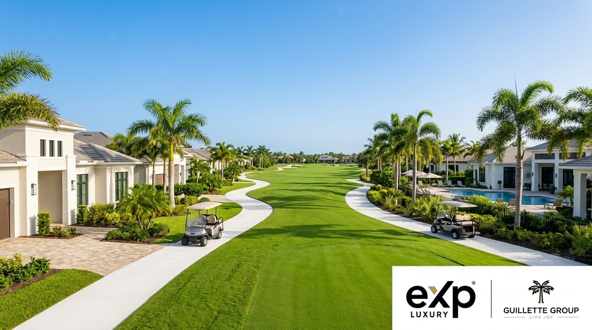 A golf course with winding cart paths, lush green fairways, and luxury homes under a clear blue sky.